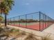 Enclosed Siesta Beach tennis court featuring well-maintained surfaces, surrounded by lush vegetation at 463 Park Trace Blvd, Osprey, FL 34229
