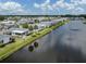 Beautiful aerial view of a lakeside manufactured home community with well-maintained lawns at 485 Schooner St, North Port, FL 34287
