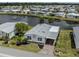 Aerial view of a home with nice landscaping and brick-paved driveway at 485 Schooner St, North Port, FL 34287