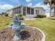 Landscaped backyard featuring a decorative fountain with lush greenery at 485 Schooner St, North Port, FL 34287