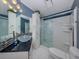 An updated bathroom with stylish vanity, glass bowl sink, elegant light fixture and a sleek glass shower at 485 Schooner St, North Port, FL 34287
