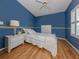A cozy bedroom with hardwood floors, a ceiling fan, and natural light creating a serene atmosphere at 485 Schooner St, North Port, FL 34287