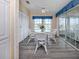 Sunlit breakfast nook with a glass table and four chairs, next to sliding glass doors at 485 Schooner St, North Port, FL 34287
