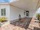 The home's carport features brick paving and an open-air design at 485 Schooner St, North Port, FL 34287