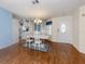 Bright dining area featuring a white table set, chandelier, and view of the home's entryway at 485 Schooner St, North Port, FL 34287