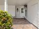 Inviting covered entrance with brick paving and white trimmed door at 485 Schooner St, North Port, FL 34287