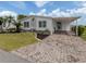 Charming home featuring a brick driveway, carport, and manicured lawn at 485 Schooner St, North Port, FL 34287