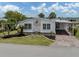 Charming home features a carport and a well-manicured landscaped yard at 485 Schooner St, North Port, FL 34287