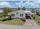 Charming home features a carport, landscaped yard, and canal view at 485 Schooner St, North Port, FL 34287