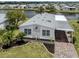 Charming home features a carport, landscaped yard, and canal view at 485 Schooner St, North Port, FL 34287