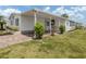 Charming home with paved walkway, manicured lawn, and vibrant landscaping at 485 Schooner St, North Port, FL 34287