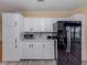 Kitchen with ample counterspace, white cabinets, and black appliances at 485 Schooner St, North Port, FL 34287