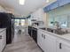 A modern kitchen with stainless steel appliances and white cabinets overlooking an eat-in kitchen at 485 Schooner St, North Port, FL 34287