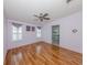A spacious main bedroom featuring hardwood floors, a ceiling fan, and an ensuite bathroom for added convenience at 485 Schooner St, North Port, FL 34287