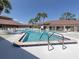 Inviting outdoor pool with tile accents, surrounded by palm trees and lounging chairs at 485 Schooner St, North Port, FL 34287