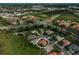 Bird's-eye view of home with terracotta roof in a suburban community, showcasing its proximity to local amenities and residences at 4912 Bella Terra Dr, Venice, FL 34293