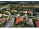 Aerial view of a home with terracotta roof, surrounded by lush greenery and other residential properties in the neighborhood at 4912 Bella Terra Dr, Venice, FL 34293