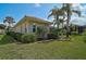 Green backyard with landscaping and view of the exterior of home at 4912 Bella Terra Dr, Venice, FL 34293