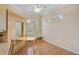 A bedroom features a murphy bed, desk, window with shutters, and storage at 4912 Bella Terra Dr, Venice, FL 34293