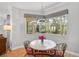 Breakfast nook with a round table, four chairs, and a view of the screened-in lanai at 4912 Bella Terra Dr, Venice, FL 34293