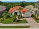 Aerial view of home with lush landscaping, brick driveway and walkway, and a two-car garage in a desirable neighborhood at 4912 Bella Terra Dr, Venice, FL 34293