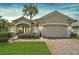 Charming home with a manicured lawn, mature landscaping and a two-car garage at 4912 Bella Terra Dr, Venice, FL 34293