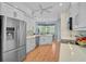 Bright kitchen featuring white cabinets, stainless steel appliances, mosaic backsplash, and tile flooring at 4912 Bella Terra Dr, Venice, FL 34293