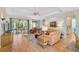 Bright and open living room with access to dining area, kitchen, and outdoor space, perfect for entertaining at 4912 Bella Terra Dr, Venice, FL 34293