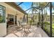 Outdoor patio with a dining table, chairs, ceiling fan, and sliding glass doors to the living room at 4912 Bella Terra Dr, Venice, FL 34293