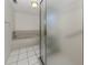 Bathroom view with tub and frosted glass enclosed shower at 528 W Venice Ave # 1, Venice, FL 34285