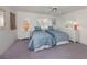 Well-lit bedroom with twin beds, carpet flooring, and white dressers beneath shuttered windows at 528 W Venice Ave # 1, Venice, FL 34285