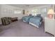 Cozy bedroom featuring two twin beds, carpet flooring, a ceiling fan, and natural light from windows at 528 W Venice Ave # 1, Venice, FL 34285
