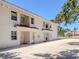 Exterior view of a two-story home featuring multiple entry doors at 528 W Venice Ave # 1, Venice, FL 34285
