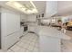 Bright kitchen featuring white cabinetry, tile flooring, modern appliances, and an open layout at 528 W Venice Ave # 1, Venice, FL 34285