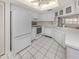 Spacious kitchen features white appliances, ample cabinetry, and tile flooring at 528 W Venice Ave # 1, Venice, FL 34285