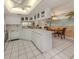Open kitchen featuring white cabinetry and an eat-in dining area at 528 W Venice Ave # 1, Venice, FL 34285