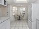 Bright kitchen with white appliances, countertops, and an eat-in area at 528 W Venice Ave # 1, Venice, FL 34285