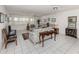 Spacious living room with tile flooring, ceiling fans, neutral furniture, and bright natural light at 528 W Venice Ave # 1, Venice, FL 34285