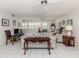 Comfortable living room with tile flooring, ceiling fans, neutral furniture, and ample natural light at 528 W Venice Ave # 1, Venice, FL 34285