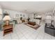 Open-concept living area featuring tile floors, comfortable seating, and access to dining and kitchen spaces at 528 W Venice Ave # 1, Venice, FL 34285