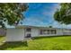 Beautiful backyard with green grass, a white fence, and tropical trees at 533 Shamrock Blvd, Venice, FL 34293