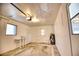 Spacious garage with storage shelf, water heater, and garage door opener at 533 Shamrock Blvd, Venice, FL 34293