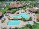 Aerial view featuring a large community pool with lounge chairs and amenities at 5674 Palmer Circle Dr # 203, Bradenton, FL 34211