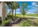Scenic backyard view featuring beautiful landscaping, grass, blue skies, and golf course at 5674 Palmer Circle Dr # 203, Bradenton, FL 34211
