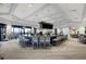 Large modern bar area featuring ample seating, sleek countertops, and multiple televisions at 5674 Palmer Circle Dr # 203, Bradenton, FL 34211