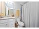 Bright bathroom featuring a vanity with sink and white cabinets and a shower with curtain at 5674 Palmer Circle Dr # 203, Bradenton, FL 34211