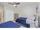 Bright bedroom with two twin beds, closet, rustic wood furniture and modern fan at 5674 Palmer Circle Dr # 203, Bradenton, FL 34211