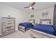 Comfortable bedroom with two twin beds, rustic wood furniture, modern fan and decor at 5674 Palmer Circle Dr # 203, Bradenton, FL 34211