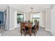 Dining room with a modern table, six chairs, and many windows for natural lighting at 5674 Palmer Circle Dr # 203, Bradenton, FL 34211
