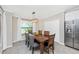 Bright dining room boasts modern light fixture, wood table, and view of the outdoors at 5674 Palmer Circle Dr # 203, Bradenton, FL 34211